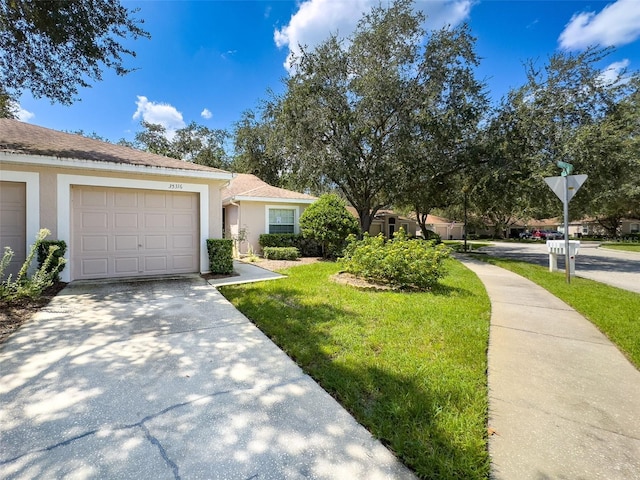 view of front of house with a garage and a front lawn