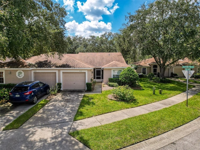 single story home featuring a front lawn and a garage