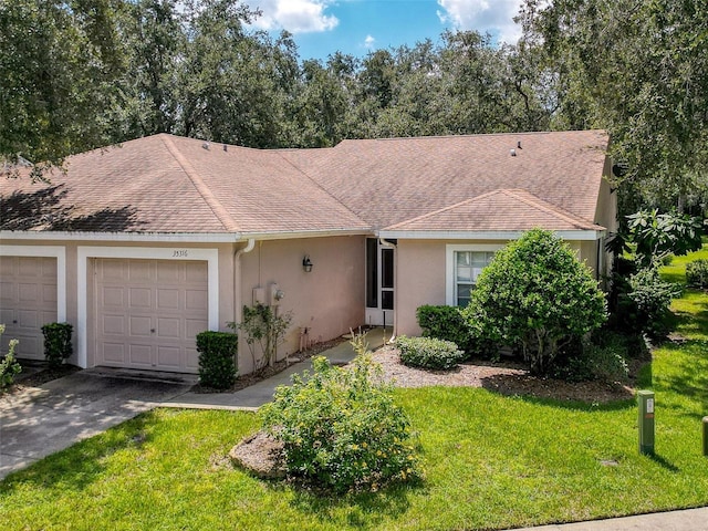 single story home featuring a garage and a front lawn