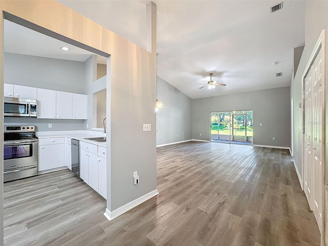 kitchen featuring light wood-type flooring, sink, white cabinetry, appliances with stainless steel finishes, and ceiling fan