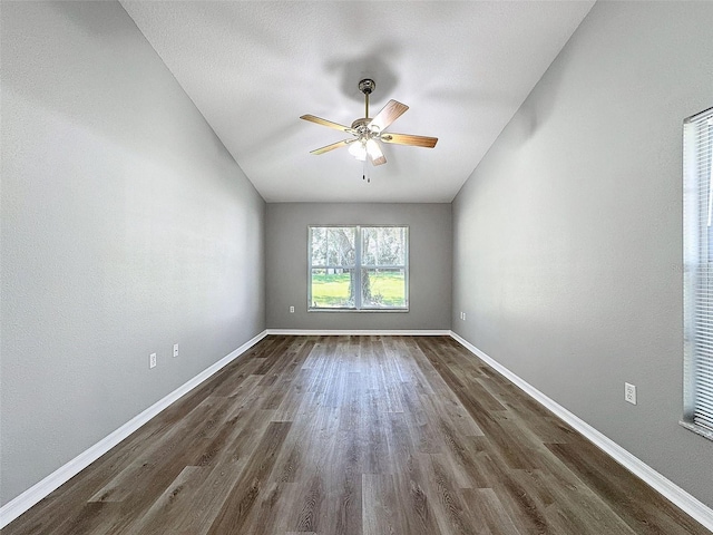 empty room featuring dark wood-type flooring and ceiling fan