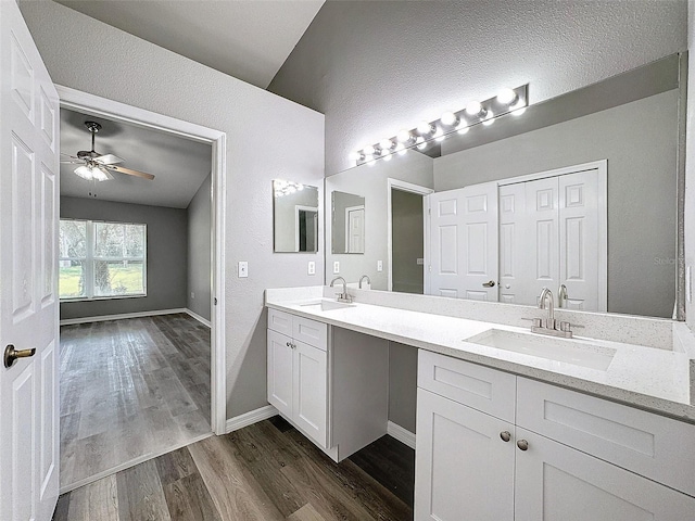 bathroom with vanity, vaulted ceiling, ceiling fan, and hardwood / wood-style flooring