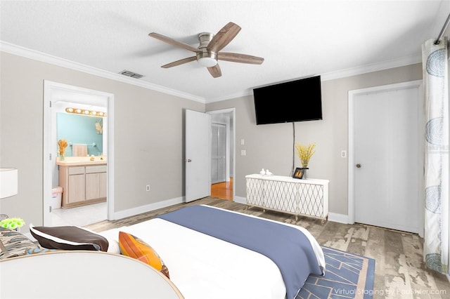 bedroom with ceiling fan, ornamental molding, wood-type flooring, a textured ceiling, and ensuite bath