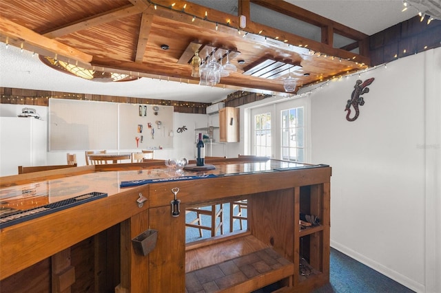 kitchen featuring wood ceiling and dark colored carpet