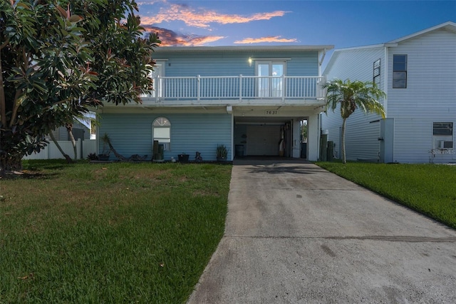 view of front of house with a carport and a yard