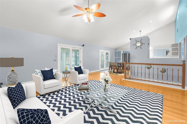 living room featuring wood-type flooring, lofted ceiling, and ceiling fan