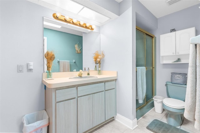 bathroom with vanity, tile patterned flooring, an enclosed shower, and toilet