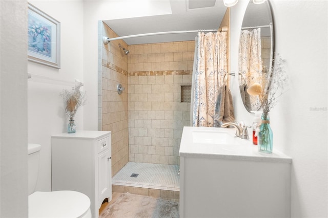 bathroom with vanity, tile patterned floors, toilet, and curtained shower