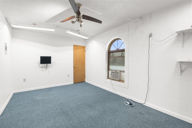 carpeted empty room featuring ceiling fan, cooling unit, and a textured ceiling