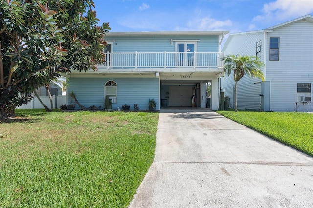 view of front of property with a carport and a front lawn