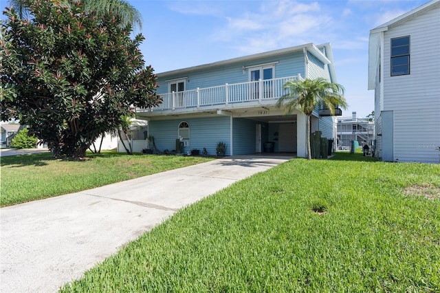 view of property with a carport and a front lawn