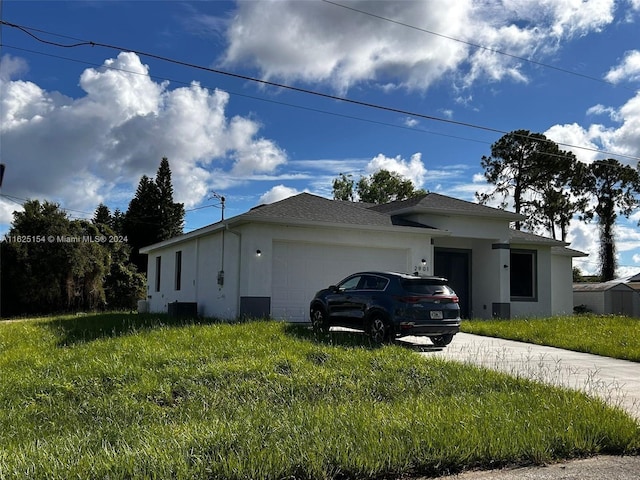 view of side of property featuring a garage and a lawn