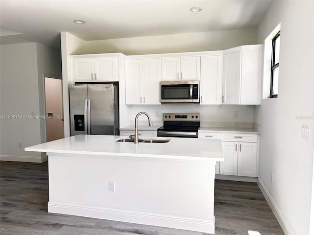 kitchen featuring white cabinets, a kitchen island with sink, appliances with stainless steel finishes, and sink