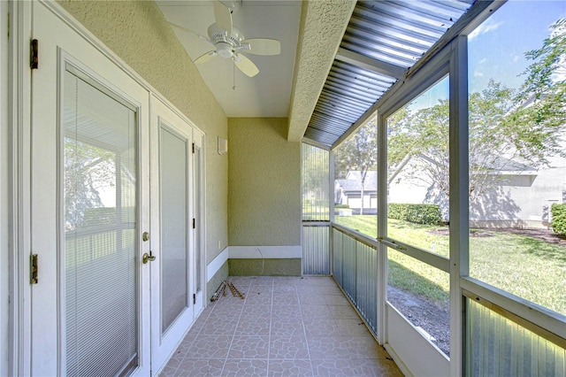 unfurnished sunroom with a wealth of natural light and ceiling fan