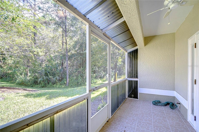 sunroom / solarium featuring ceiling fan