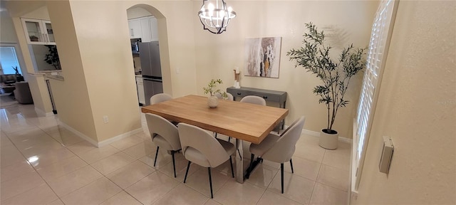 tiled dining room with a notable chandelier