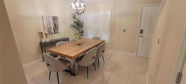 tiled dining room with a chandelier