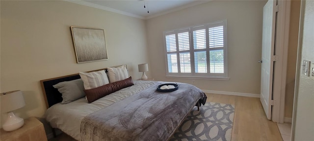 bedroom with ornamental molding and light wood-type flooring