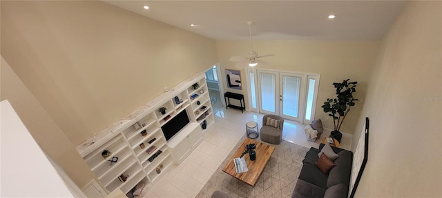 tiled living room with high vaulted ceiling, french doors, and ceiling fan