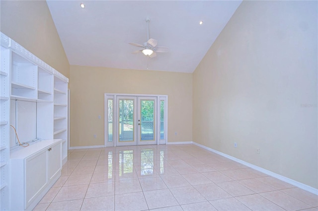 tiled spare room featuring french doors, ceiling fan, and high vaulted ceiling