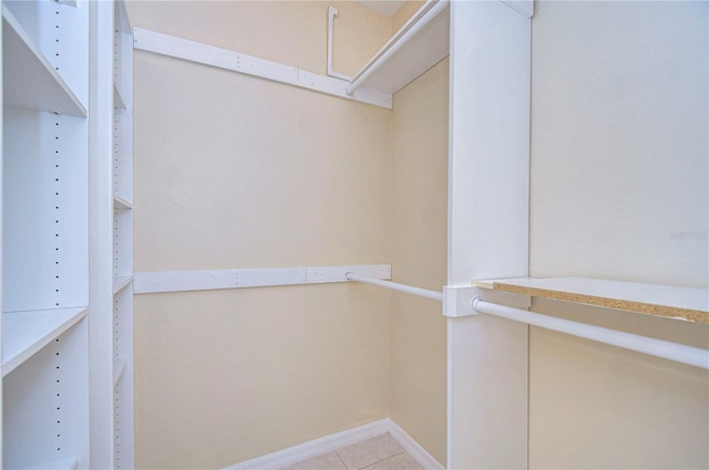 walk in closet featuring light tile patterned flooring