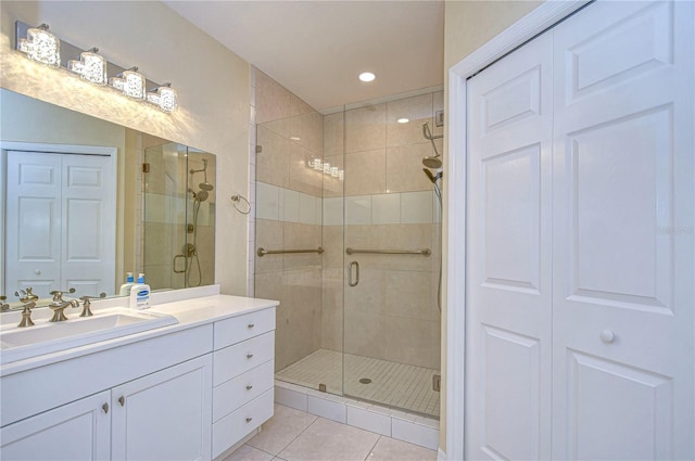 bathroom with vanity, an enclosed shower, and tile patterned flooring