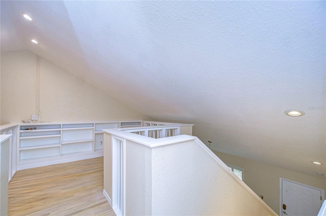 interior space with light hardwood / wood-style flooring and a textured ceiling