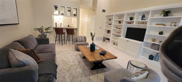 living room featuring visible vents and light tile patterned flooring