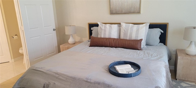 bedroom featuring light tile patterned flooring and baseboards