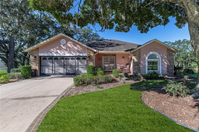 ranch-style home with a garage and a front yard