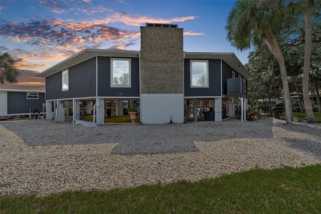 back house at dusk featuring a patio area