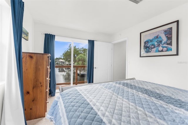 bedroom featuring carpet flooring and a water view