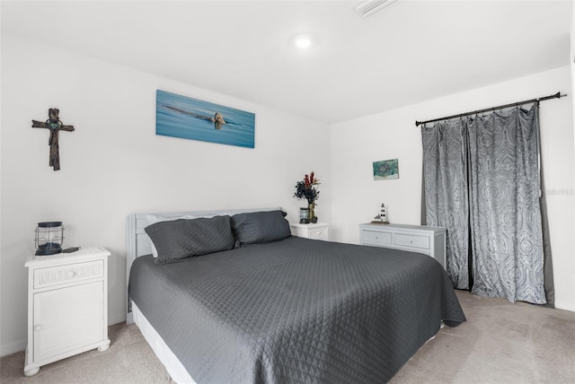 bedroom featuring light carpet