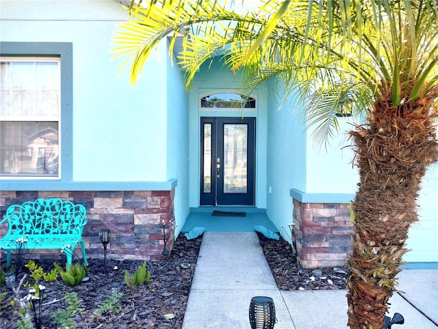 doorway to property featuring stucco siding