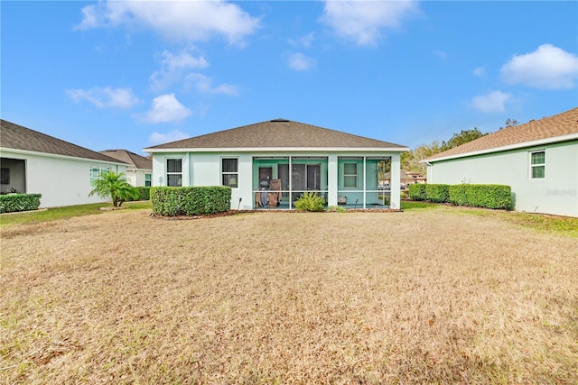 back of property with a sunroom