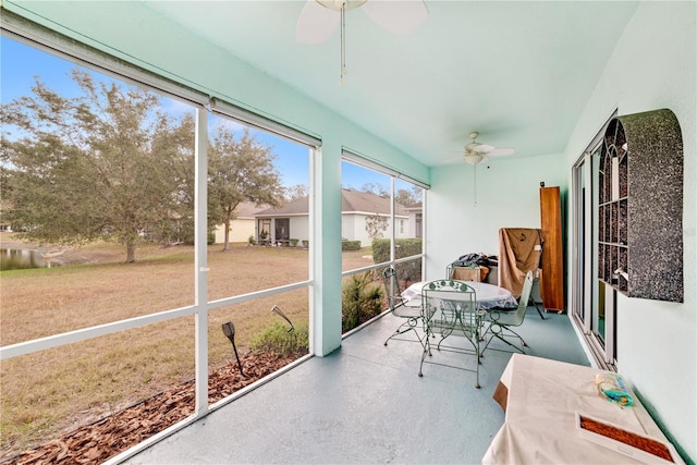 sunroom / solarium featuring ceiling fan