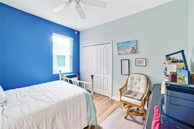 bedroom featuring wood-type flooring, a closet, and ceiling fan