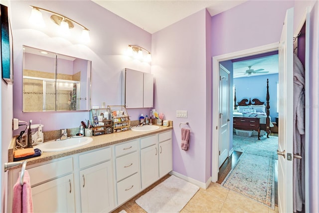 bathroom featuring tile patterned flooring, vanity, a shower with door, and ceiling fan