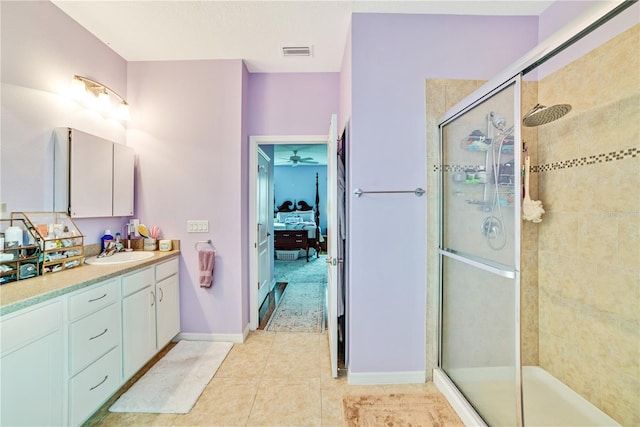 bathroom featuring tile patterned flooring, vanity, ceiling fan, and a shower with shower door