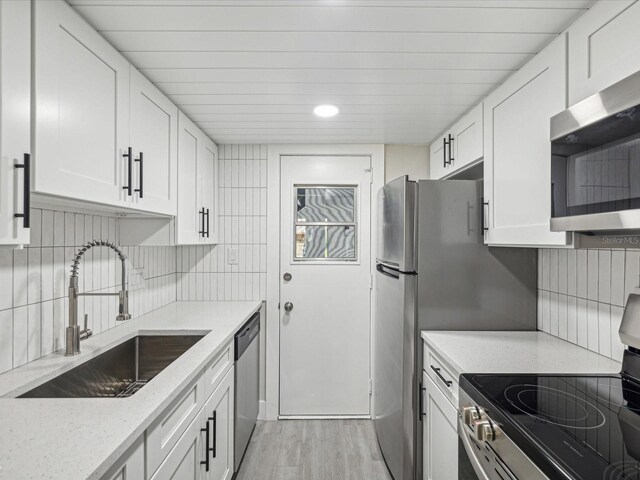 kitchen featuring white cabinetry, sink, and stainless steel appliances