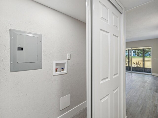 washroom with washer hookup, electric panel, and hardwood / wood-style floors