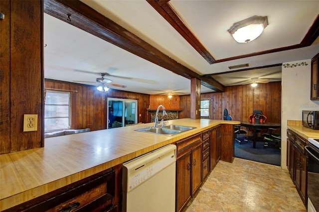 kitchen with ceiling fan, wooden walls, sink, and black appliances