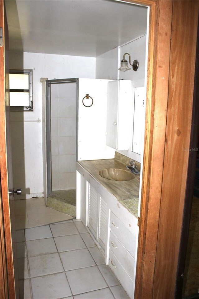 bathroom featuring vanity, tile patterned floors, and a shower with door