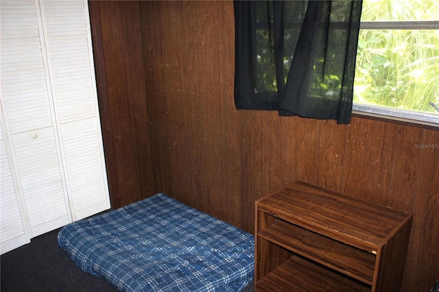 bedroom featuring wood walls