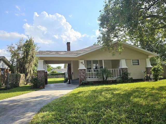 ranch-style house with a porch, a front lawn, and a carport