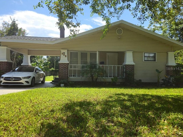 view of front of house featuring a front yard, covered porch, and a carport