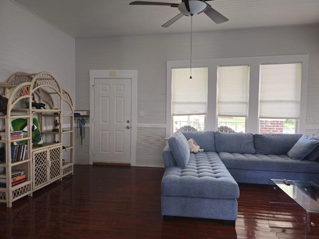 living room featuring dark hardwood / wood-style floors, ceiling fan, and a wealth of natural light