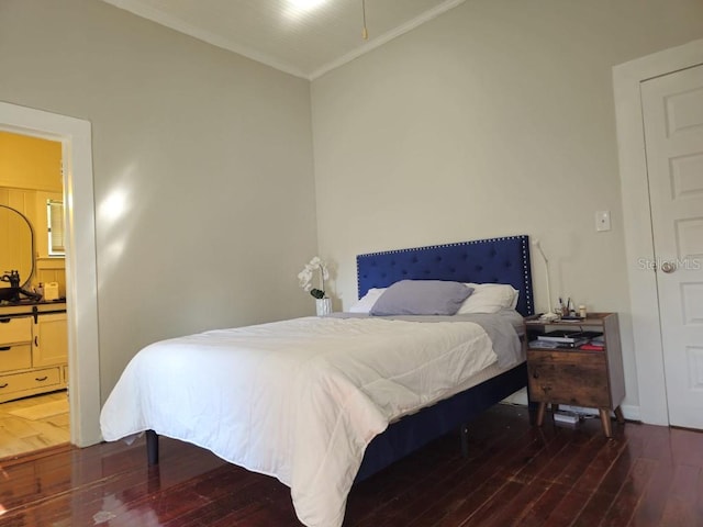 bedroom with hardwood / wood-style flooring and crown molding