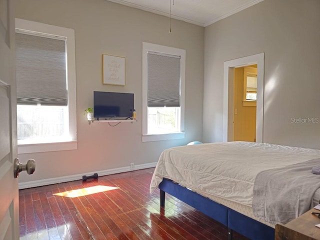 bedroom featuring ornamental molding and dark hardwood / wood-style flooring