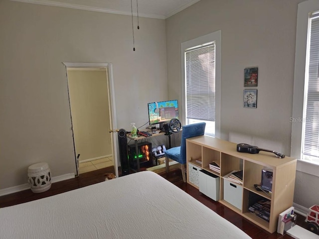 bedroom featuring ornamental molding and dark hardwood / wood-style floors